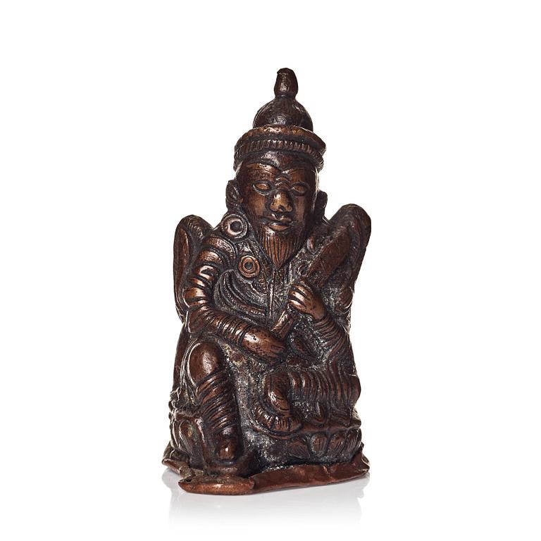 A Tibetan copper alloy figure of a deity.