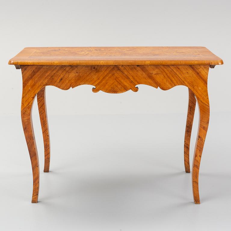 An elm veneered Rococo games table, 18th Century.