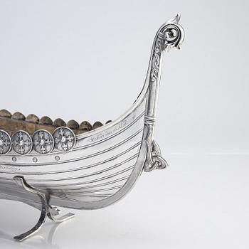 A Norwegian early 20th century silver longboat, mark of David Andersen and two small ones with Swedish marks.