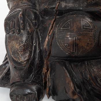 A Chinese wooden figure of Budai with silver inlays, Qing dynasty (1644-1912).