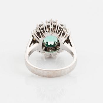 An 18K white gold ring set with a step-cut emerald.