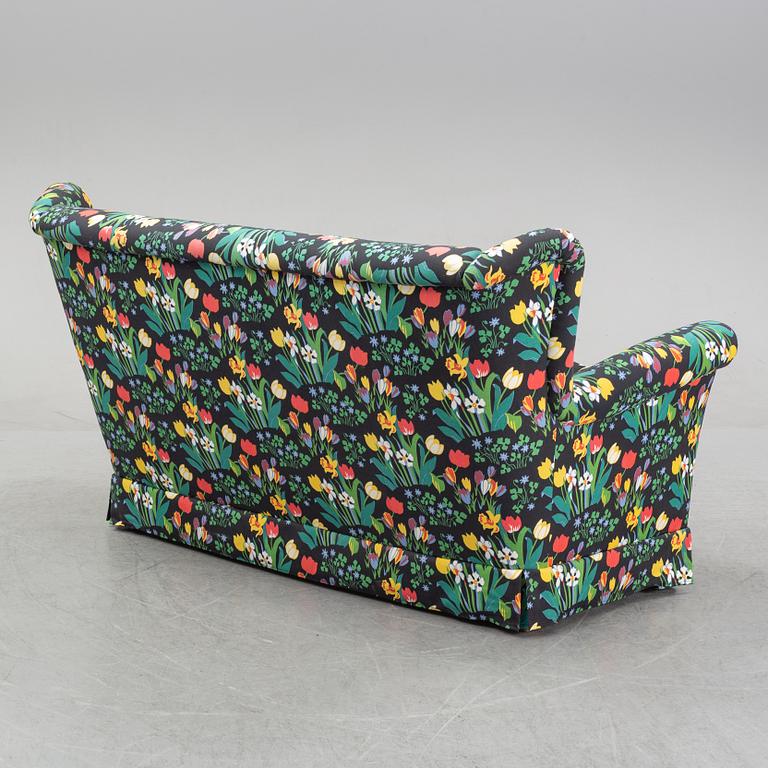 A sofa and wingback chair, later part of the 20th Century.