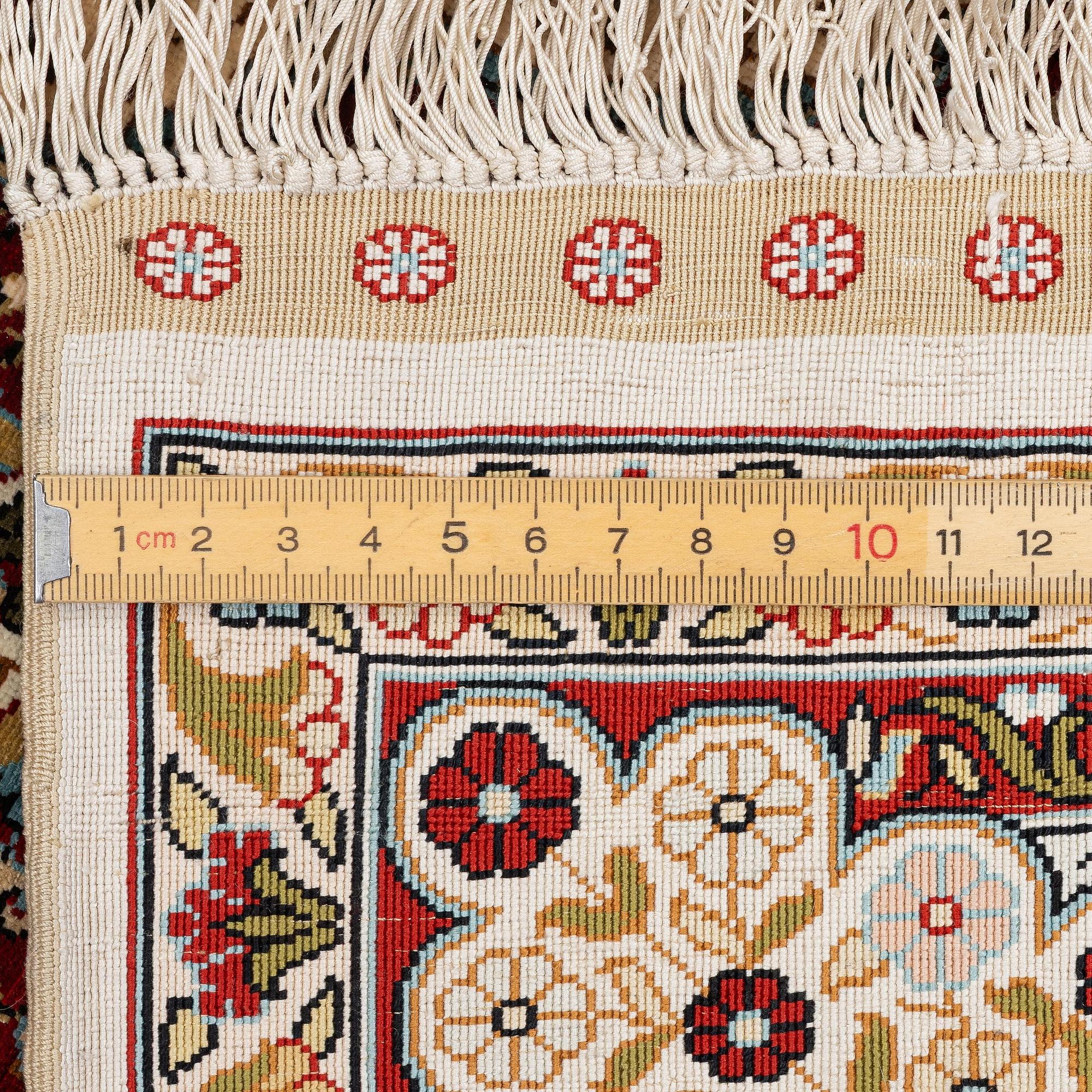 A semi-antique silk Hereke rug, West Anatolia, c. 180 x 121 cm.