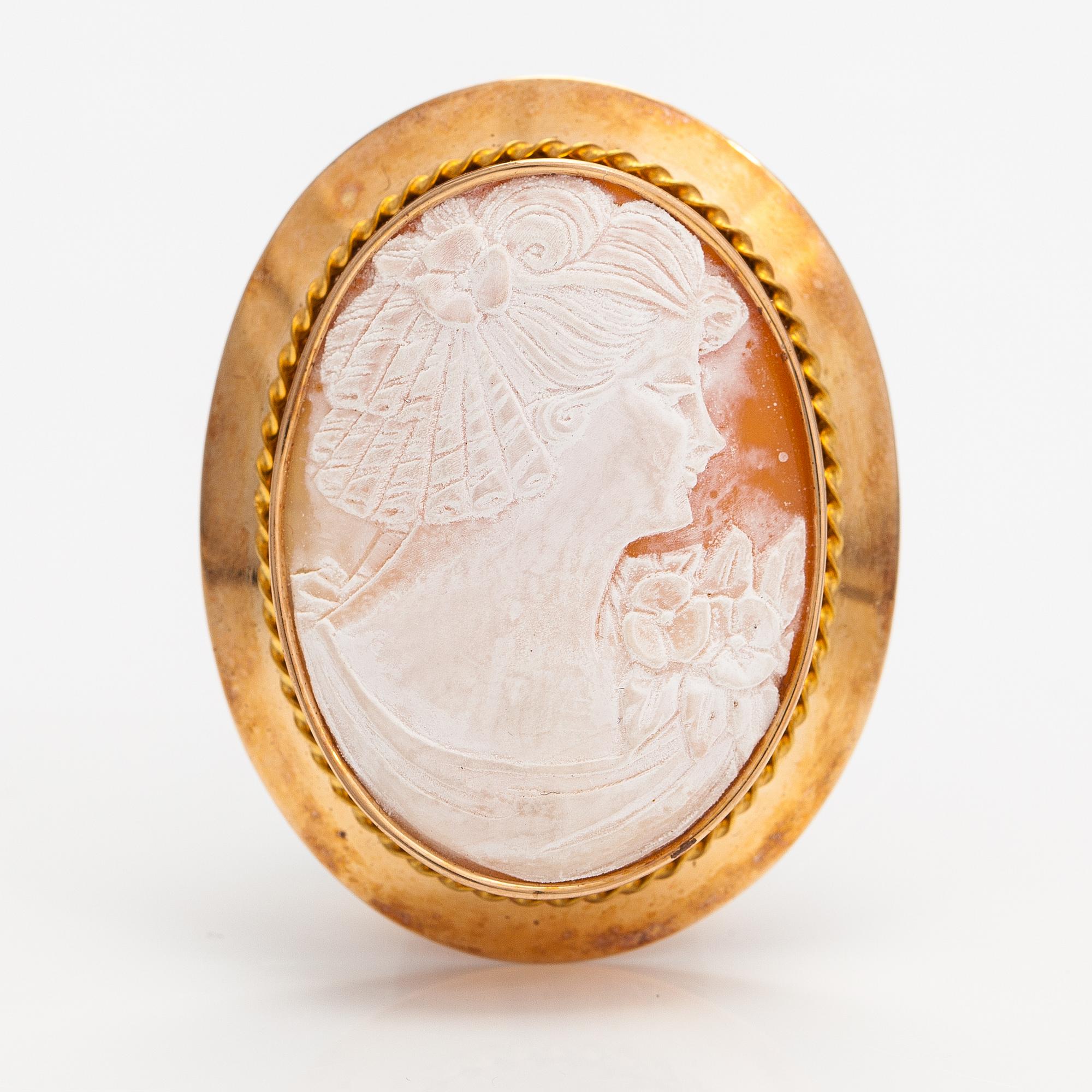 Two brooches and a ring, 14K and 18K gold and sea shell cameos.