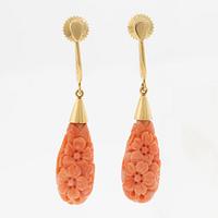 A pair of 18K gold earrings with coral drops.