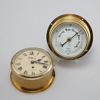 A wall clock from Smith Empire and a barometer, made in the fourth quarter of the 20th century.