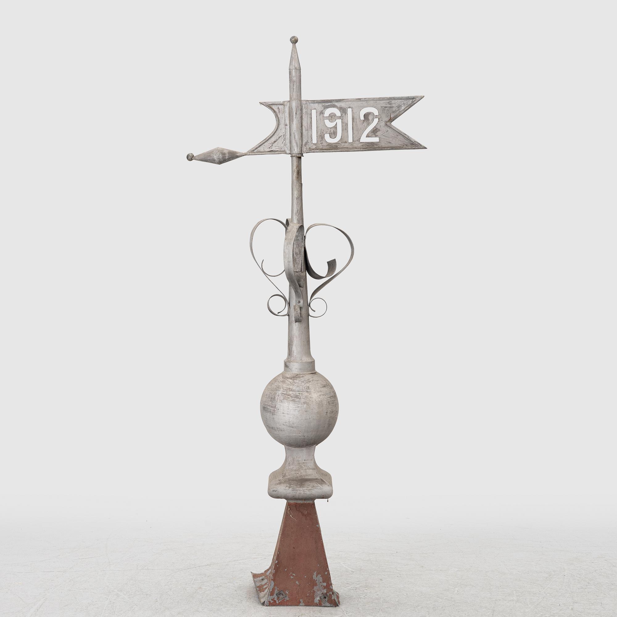 Tower spire with weather vane dated 1912.