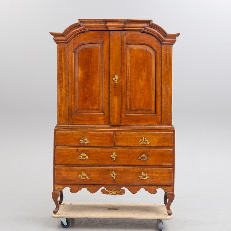 A mid 18th century rococo oak cabinet.