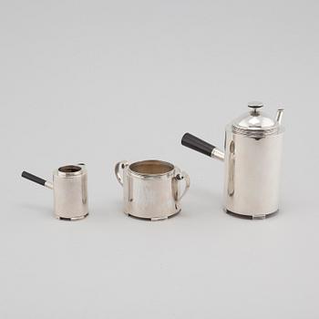 A silver coffee pot, a creamer and a sugar bowl by C F Carlman in Stockholm, 1937 and 1945.