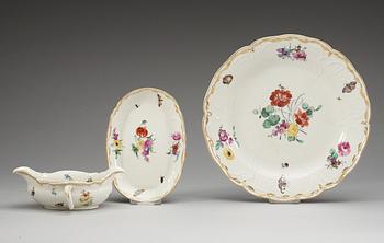 A set of four Berlin chargers and a sauce boat with stand, 18th Century.