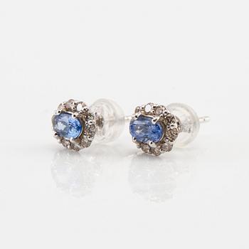 Earrings in 18K white gold with oval faceted sapphires and round brilliant-cut diamonds.