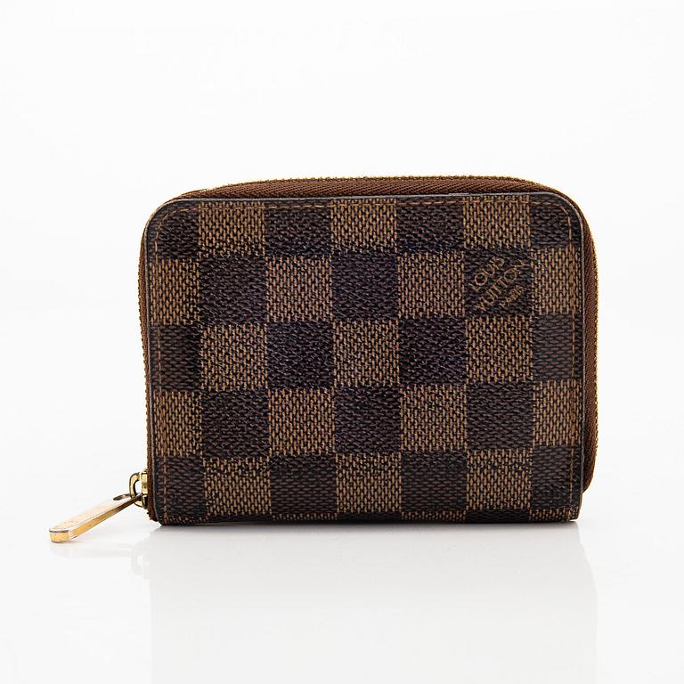 Louis Vuitton, a 'Zippy Coin Purse' wallet and an 'Inventeur' belt.