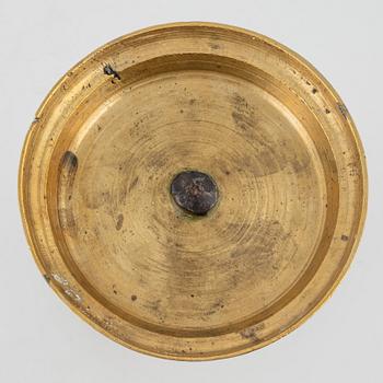 A brass candlestick, 18th century.