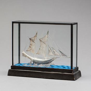 A SÌLVER SHIP MODEL.