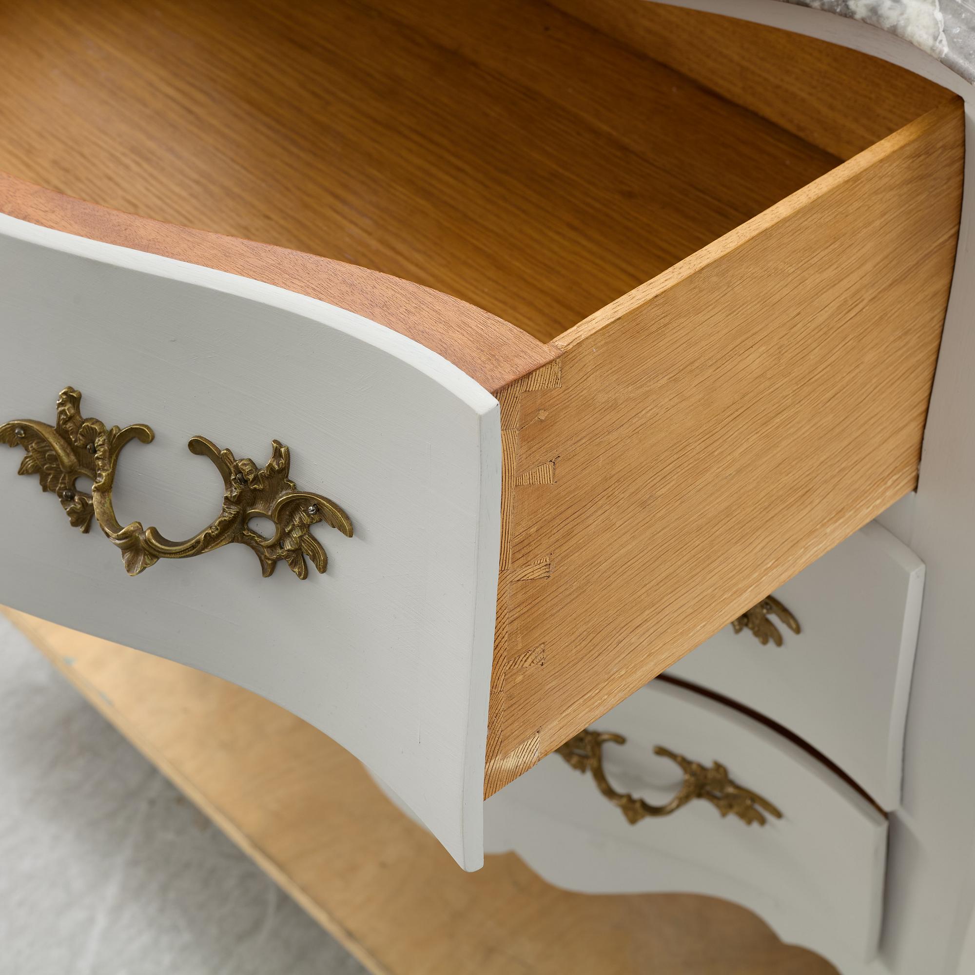 A Rococo style chest of drawers, mid-20th Century.