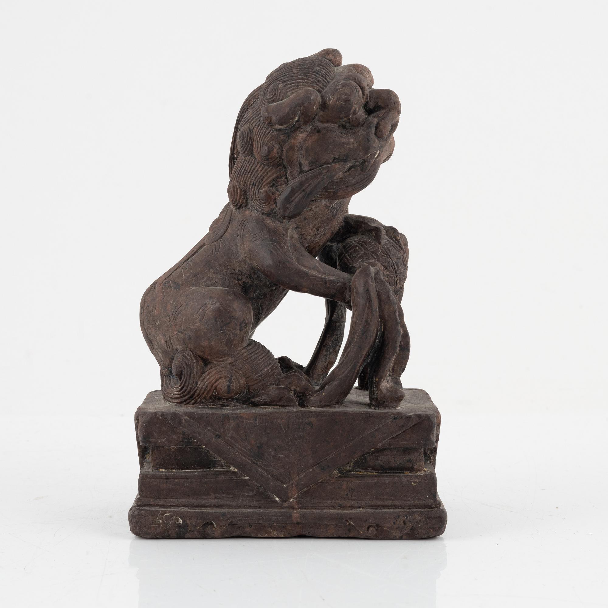 A stone sculpture of a mythical creature and four textile fragments, Qing dynasty.