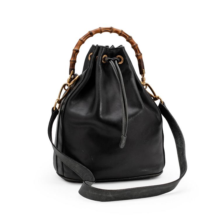 GUCCI, a dark blue leather purse.