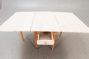 A painted gate legged table later part of the 19th century.