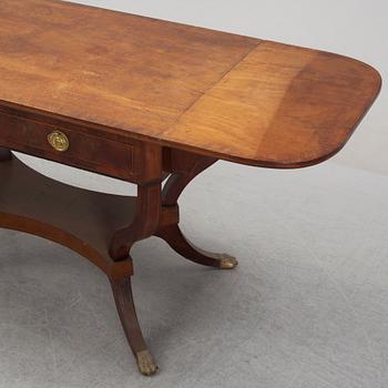 An Empire style mahogany  center table from around the year 1900.