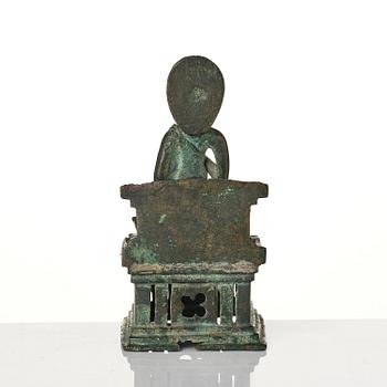 A bronze Buddha Vairocana, Eastern Java, 10th century.