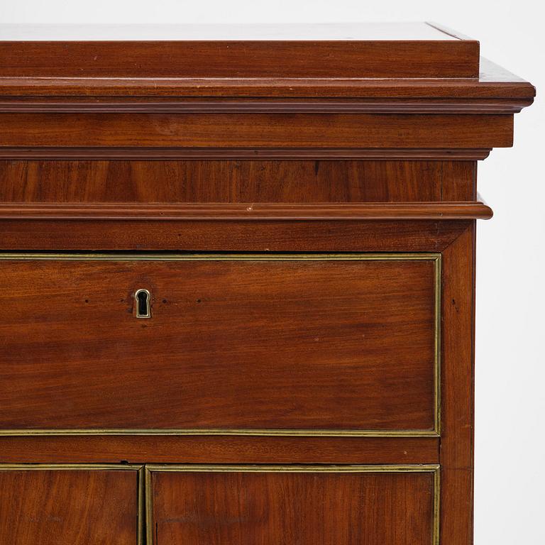 A late Gustavian mahogany column-cabinet, Stockholm, circa 1800.