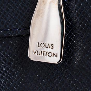 Louis Vuitton, a Navy Taiga 'Sasha' Messenger bag.