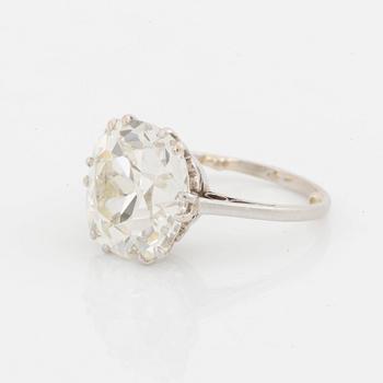 A platinum ring set with a cushion-formed old-cut diamond.