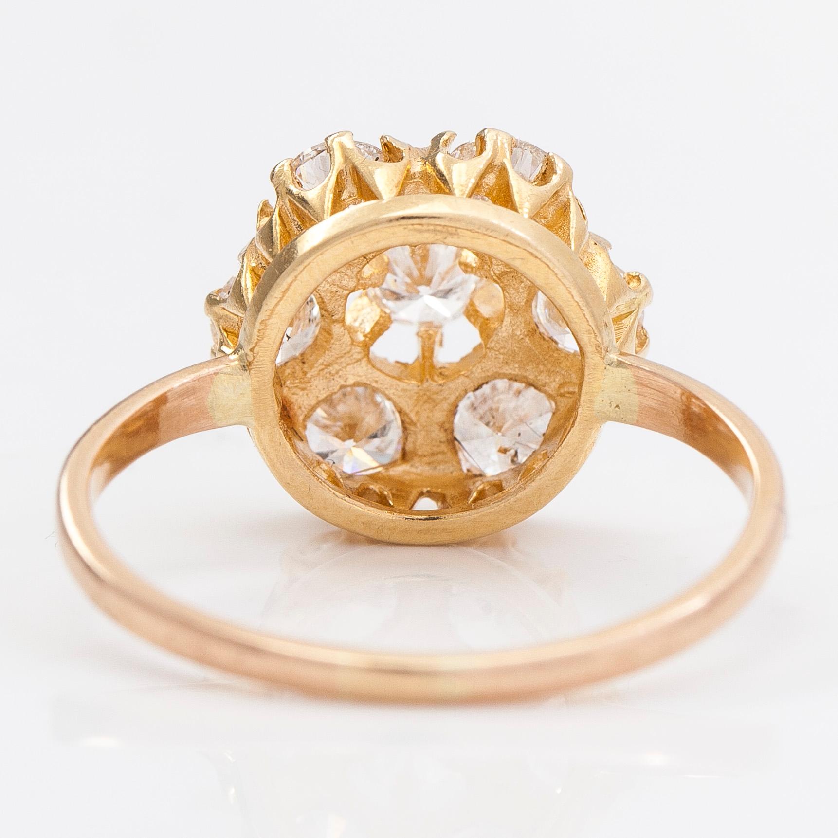 A 14K and 18K gold and diamond cluster ring ca 1.15 ct in total.