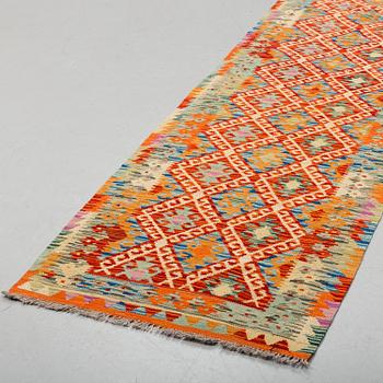 A kilim runner, 394 x 77 cm.