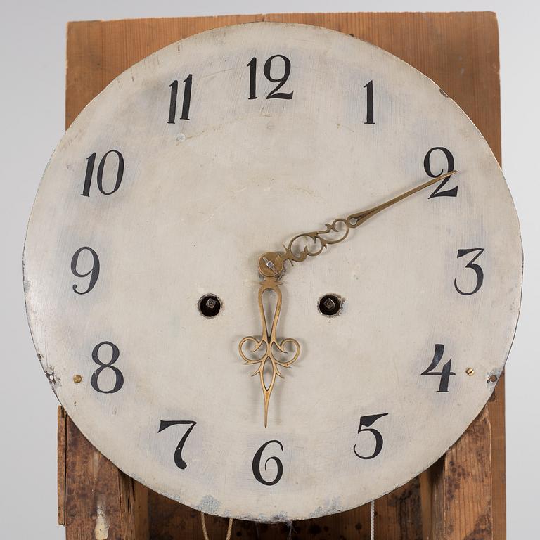 a painted grandfather-clock from the first half of the 19th century.