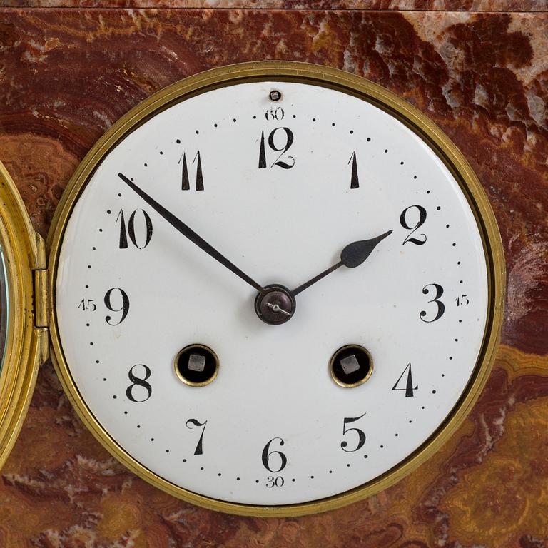 An early 20th century mantle clock with a bronze sculpture signed M. Charny.