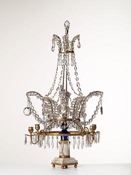 A presumably Russian Louis XVI gilt brass and cut glass four-light table girandole.