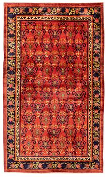 335. An East Turkestan silk carpet, c. 308 x 182 cm.