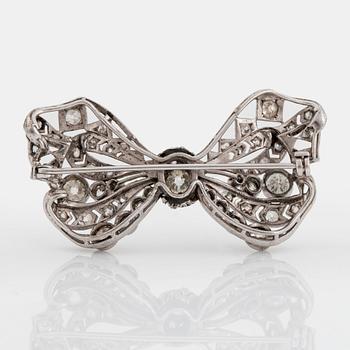 A silver bow brooch set with old-cut diamonds.
