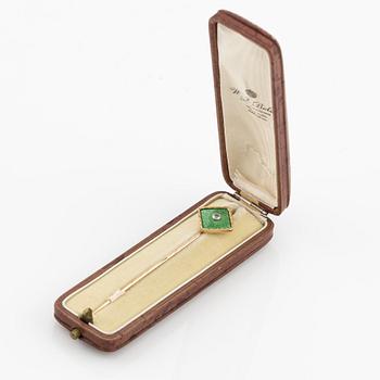 A tie pin 14K gold and guilloché enamel with a diamond.