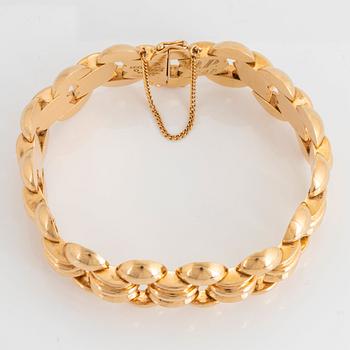 An 18K gold bracelet.