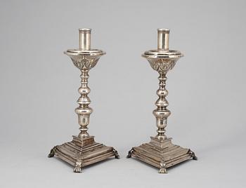 569. A pair of possebly Spanish or South American 18th century candelsticks, unidentified makers mark.