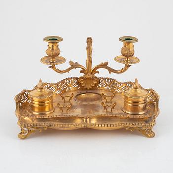 A gilt inkwell and candle holder, around 1900.