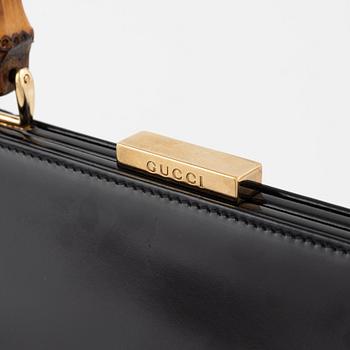 Gucci, a patent leather and bamboo bag.