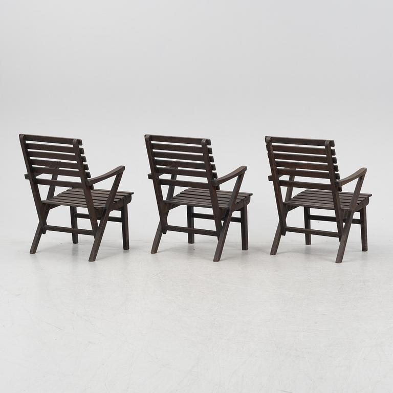 Carl Malmsten, a set three stained pine armchairs, Igelstaverken, second half of the 20th Century.