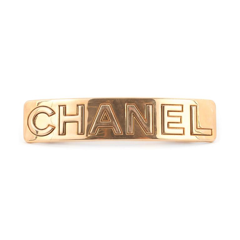 CHANEL, a gold colored metall hair clip.