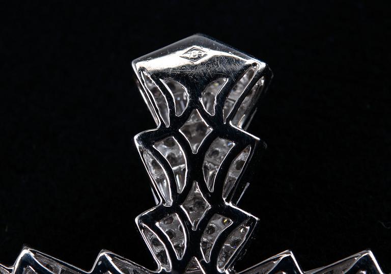 A CROSS,  brilliant and baguette cut diamonds c. 6.50 ct. Weight 14,3 g.