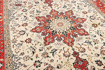 A Tabriz, part silk carpet, c. 300 x 199 cm.
