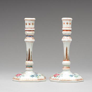 A pair of famille rose candle sticks, Qing dynasty, Qianlong (1736-95).