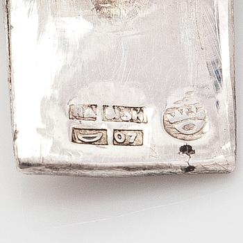 A silver bracelet and ring with turquoises. China.