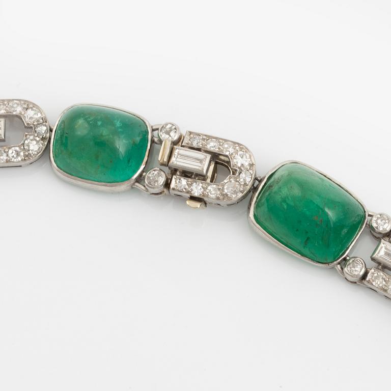 An art deco platinum necklace/bracelet combination with cabochon-cut emeralds.