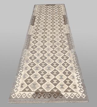A Kilim runner carpet. 393 x 89 cm.