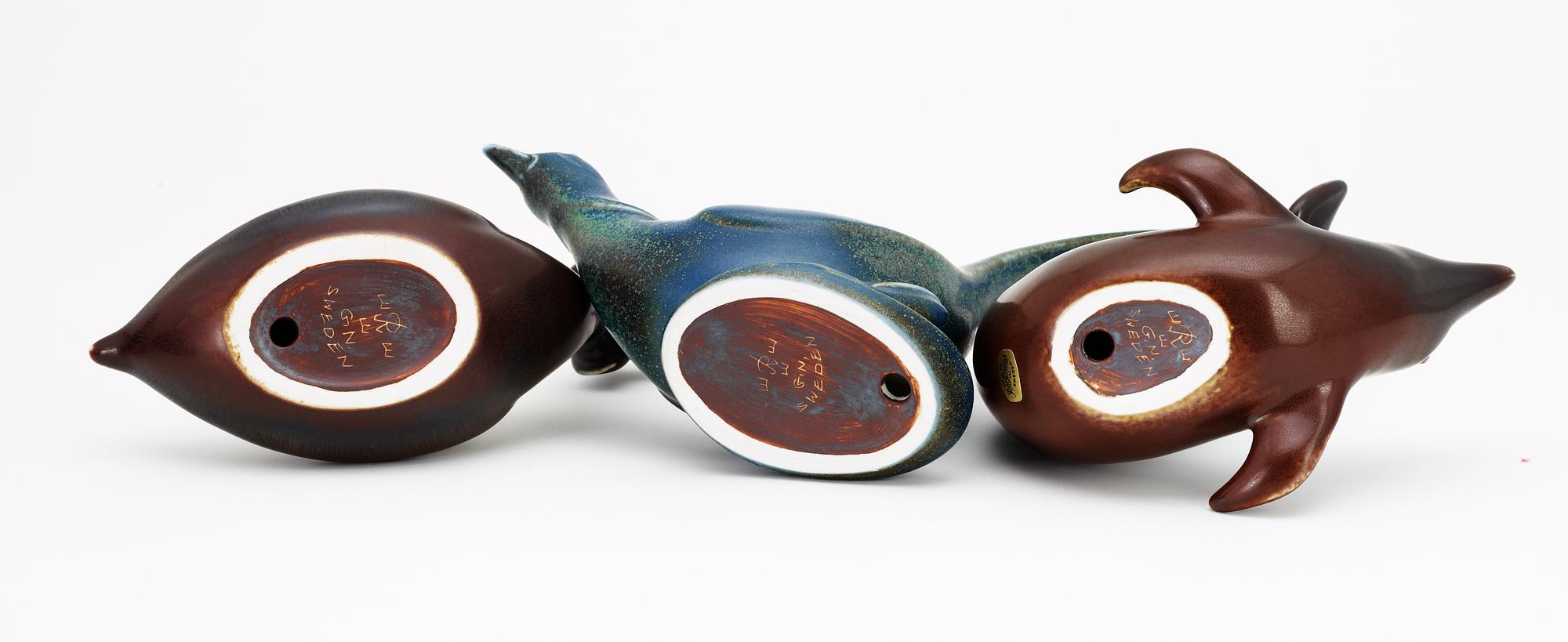 Three Gunnar Nylund stoneware figures, a dolphin, a pheasant and a great crested grebe, Rörstrand.