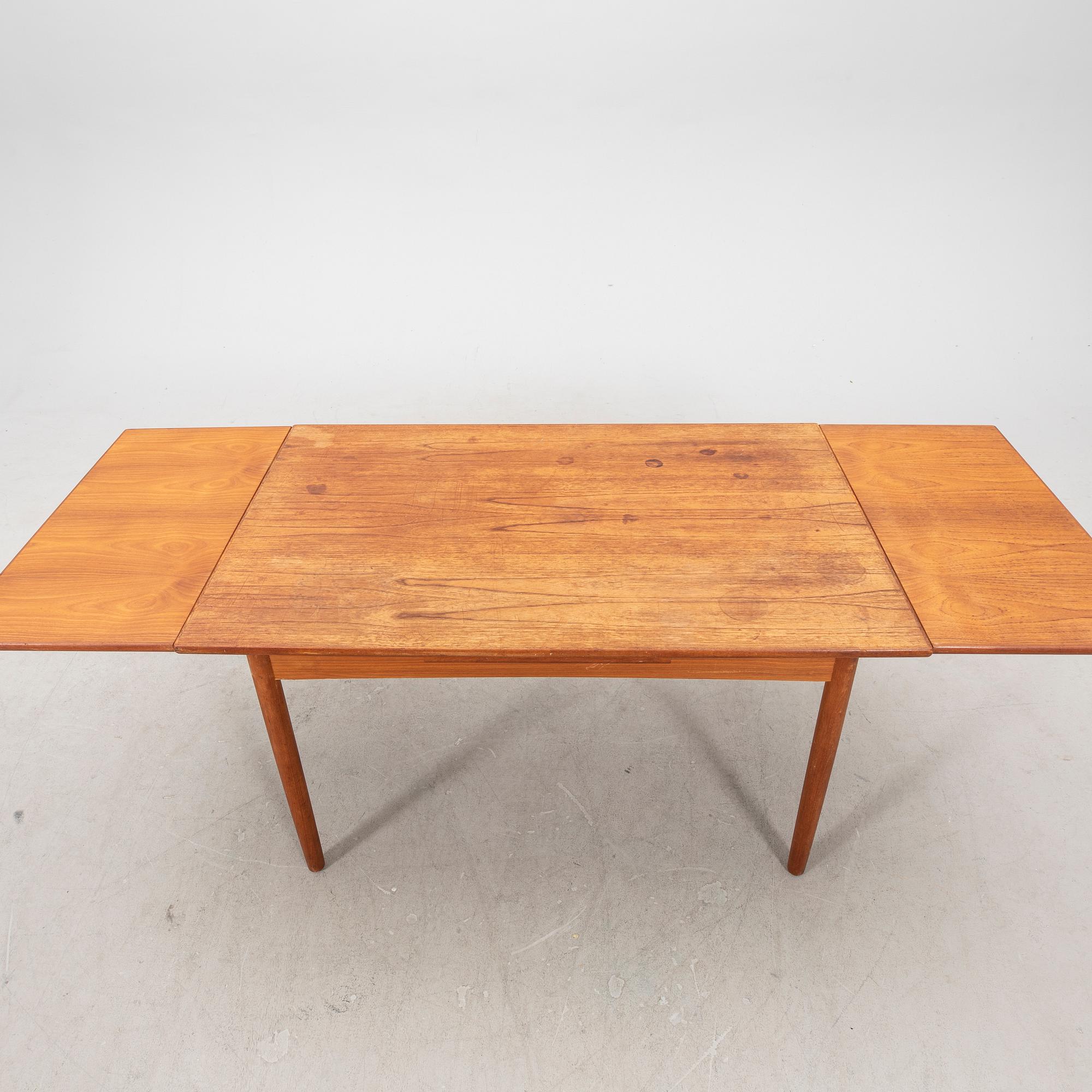 A 1960s teak dining table.
