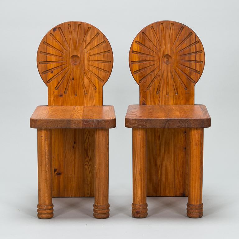 A pair of 1970s pine wood chairs.